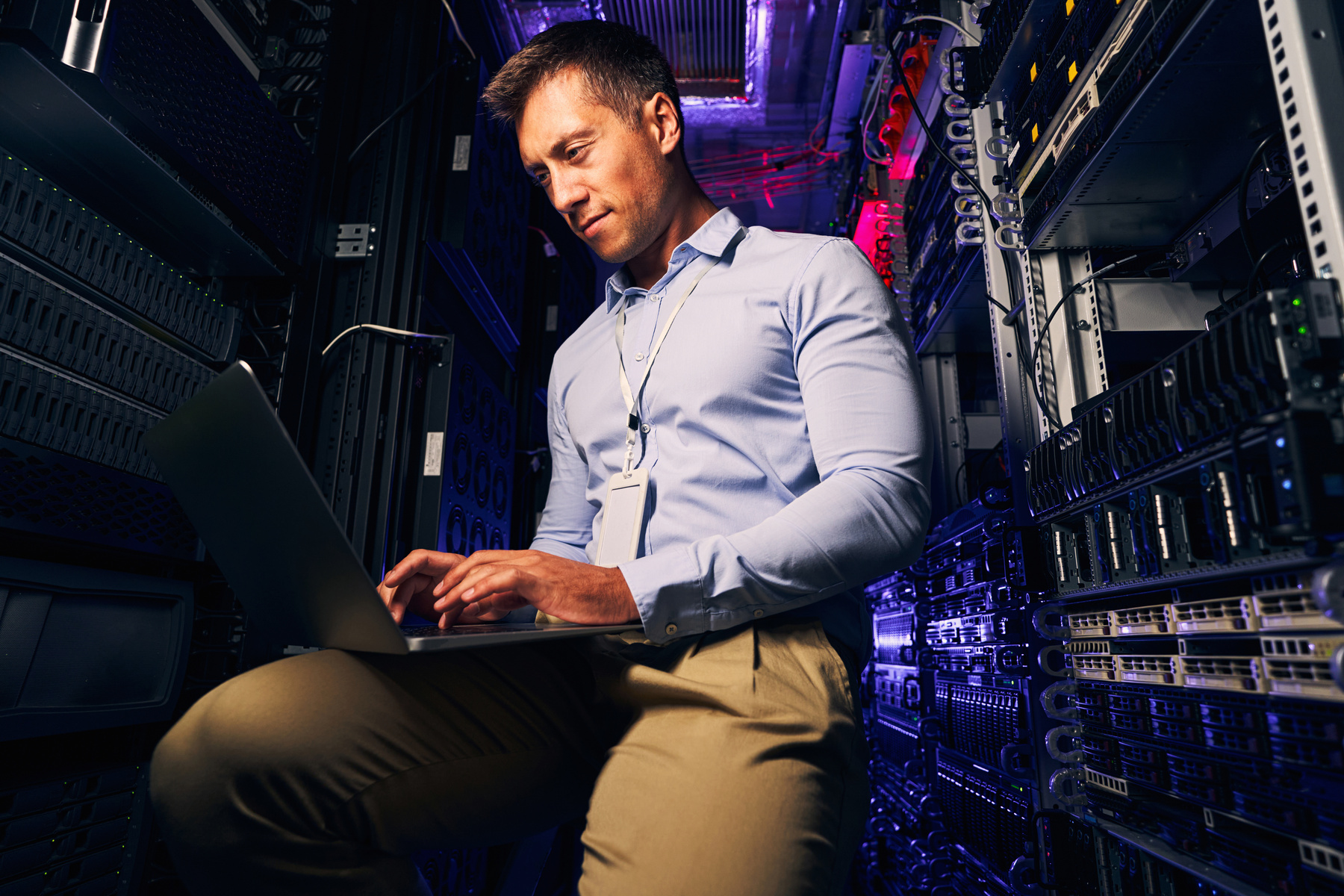 Focused experienced system administrator testing networking equipment